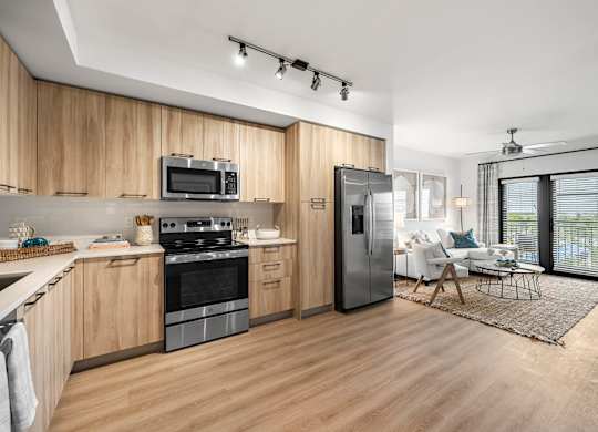 a kitchen and living room with a stove and refrigerator