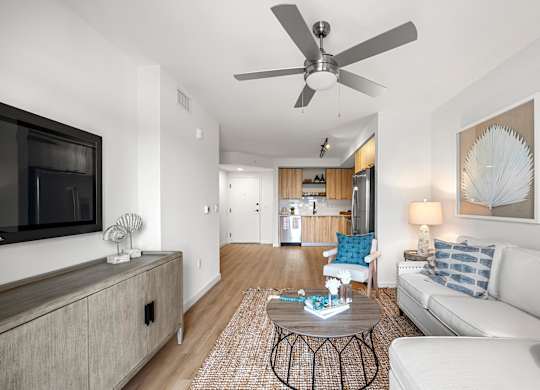 a living room with a couch and a ceiling fan