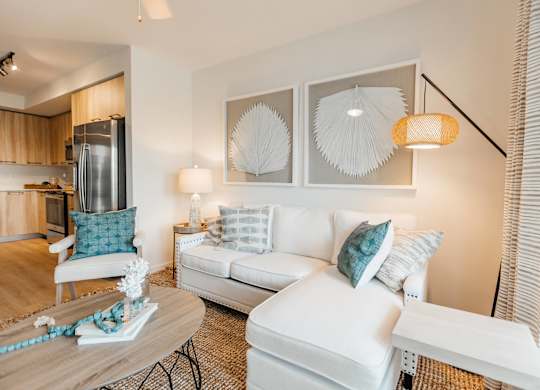 a living room with a white couch and a table
