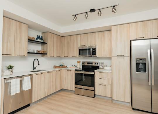 a kitchen with wooden cabinets and stainless steel appliances