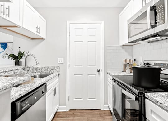 A kitchen with a black pot on the stove at Paces Pointe Apartment Homes, Matthews, NC