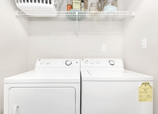 Two white dryers are in a laundry room at Paces Pointe Apartment Homes, Matthews, NC, 28105