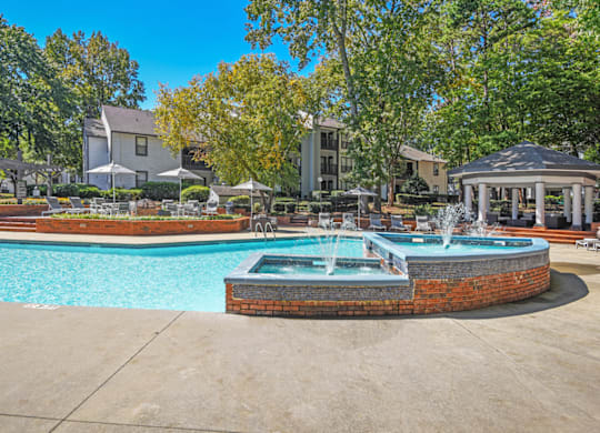A pool with a fountain in the middle of it at Paces Pointe Apartment Homes, North Carolina, 28105