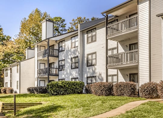 Apartment building with a balcony on the second floor at Paces Pointe Apartment Homes, Matthews, North Carolina