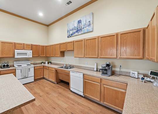 A kitchen with wooden cabinets and white appliances.