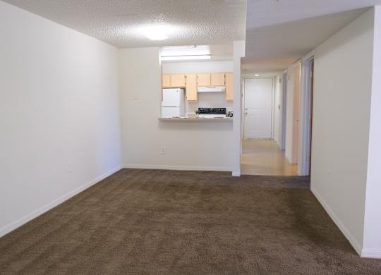 A room with brown carpet and white walls.