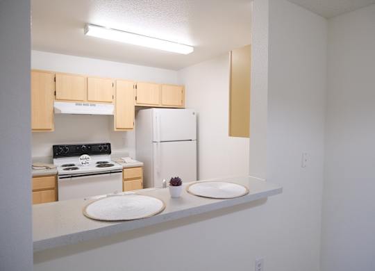 A kitchen with a stove, oven, and refrigerator.