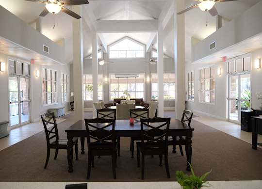 A dining room with a table set for six.