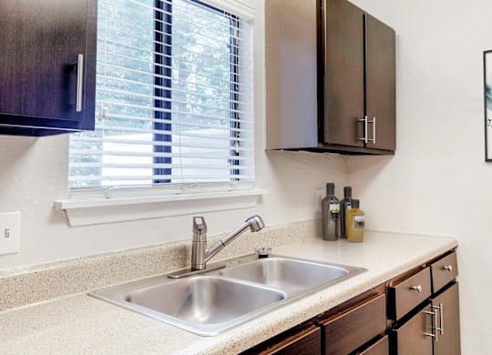 A kitchen with a sink and a window at Regency Park Apartment Homes, Raleigh