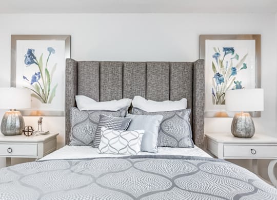 A bed with a grey headboard and a grey patterned bedspread at Regency Park Apartment Homes, Raleigh, North Carolina