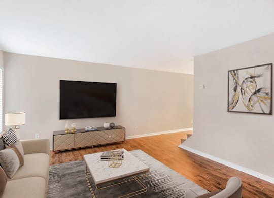 A living room with a couch, coffee table, and a painting on the wall at Regency Park Apartment Homes, Raleigh, NC, 27616