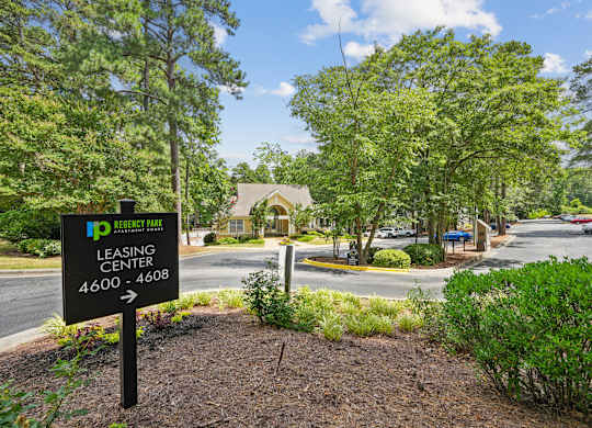 A sign for the Ip Leasing Center stands in front of a building at Regency Park Apartment Homes, North Carolina
