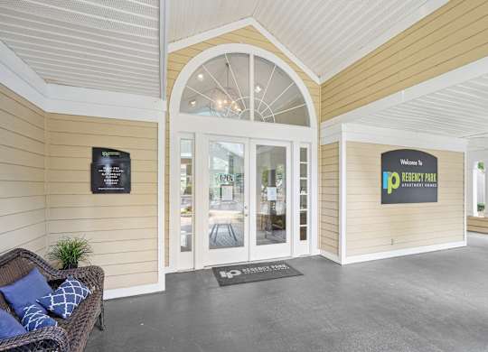 A welcoming entrance to a residential building with a sign on the wall at Regency Park Apartment Homes, Raleigh, 27616
