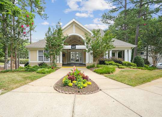 A house with a front yard and a flower bed in front of it at Regency Park Apartment Homes, Raleigh, NC