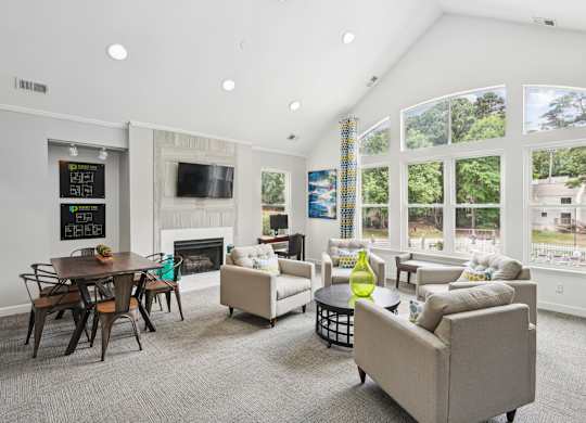 A living room with a fireplace and a dining table at Regency Park Apartment Homes, North Carolina