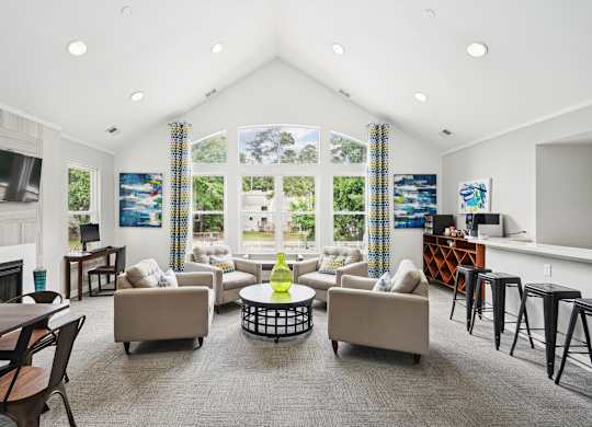 A living room with a fireplace and a large window at Regency Park Apartment Homes, Raleigh, North Carolina