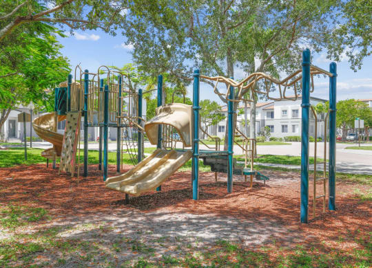a playground with slides and monkey bars at the whispering winds apartments in pearland, tx