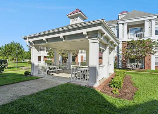 A white building with a porch and a sign that reads "NICE".