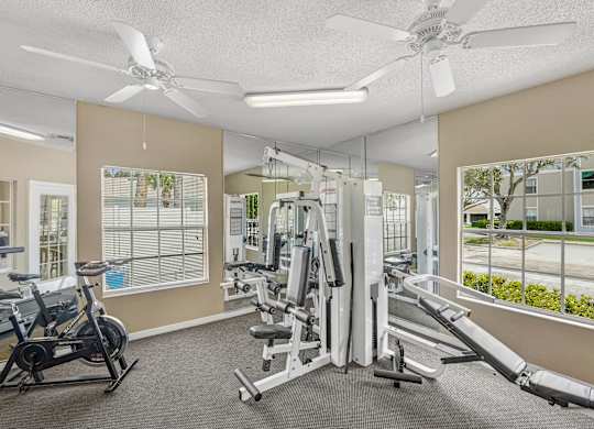 Fitness room with workout equipment in front of a mirror