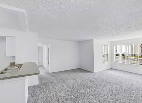 Interior of apartment facing the kitchen and dining area from the living room