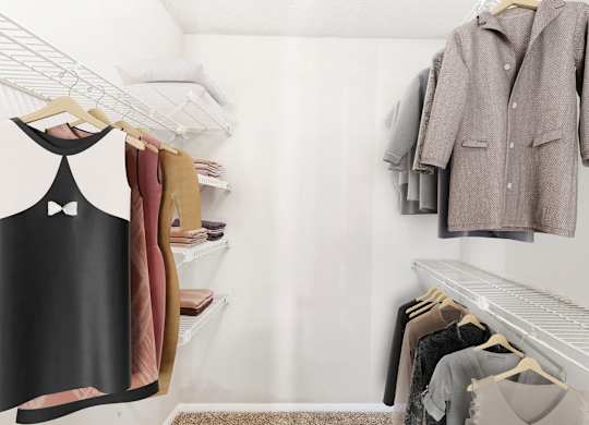 A black dress with a white pattern hangs on a rack in a clothing store.