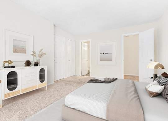 A bedroom with a bed, nightstand, and a cabinet with drawers.