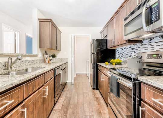 A kitchen with wooden cabinets and a black stove top oven.
