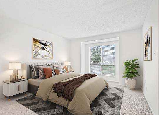 A bedroom with a large bed and a painting on the wall.