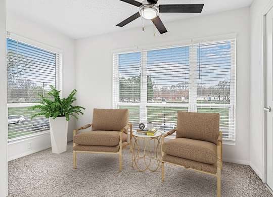 A room with two chairs and a table in front of a window with blinds.