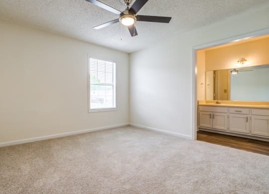 bedroom with ceiling fan and carpeted flooring
