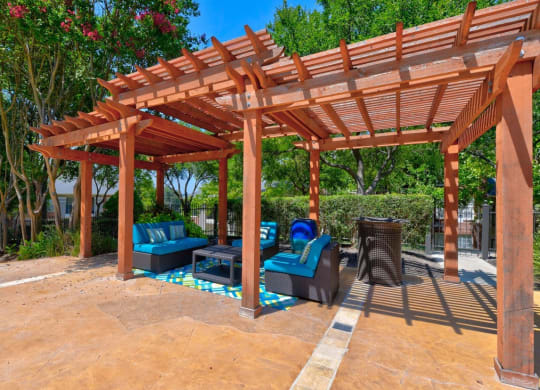 a wooden pergola with seating area