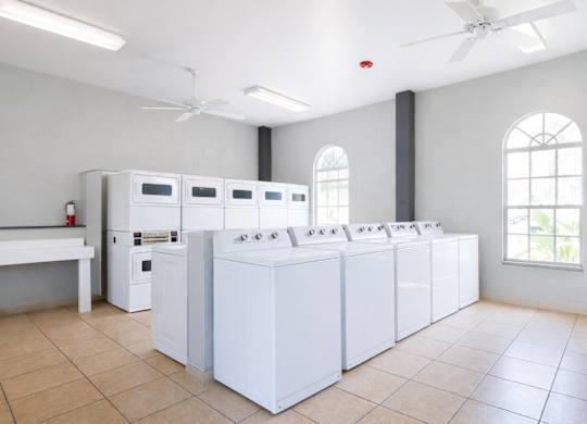 A row of washing machines in a laundromat.