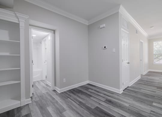 room with hardwood-style flooring and built-in shelving