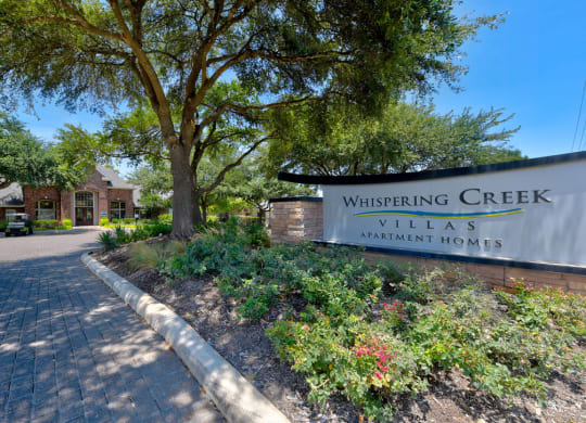 whispering creek villas apartment sign