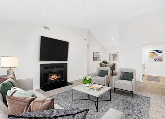 A living room with a fireplace and a couch. at Woodlyn on the Green Apartment Homes, Cary, North Carolina