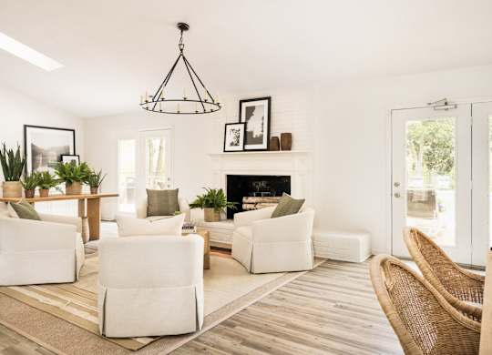 A living room with a fireplace and a chair. at Woodlyn on the Green Apartment Homes, Cary, North Carolina