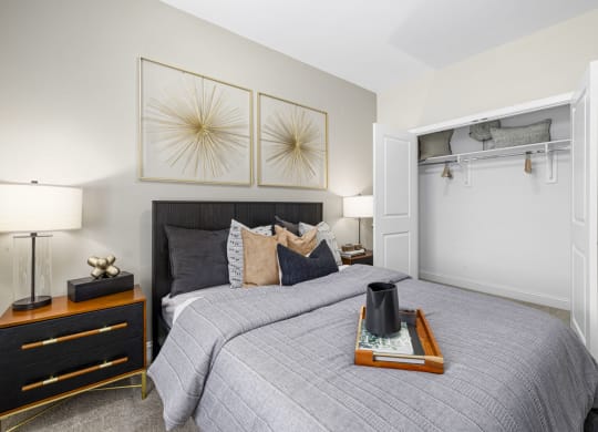 a bedroom with a bed and two paintings on the wall