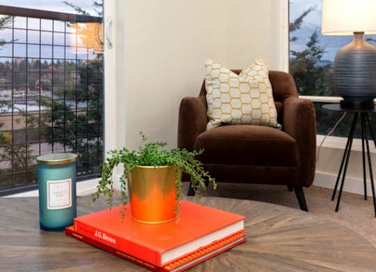 a living room with a coffee table and a chair