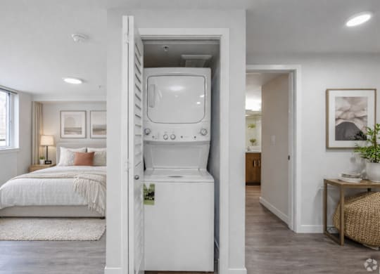 A white vintage television is built into a wall in a modern bedroom.