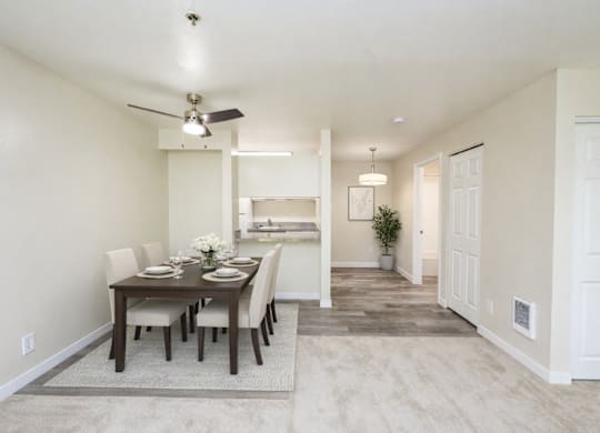 A dining room with a table set for six.
