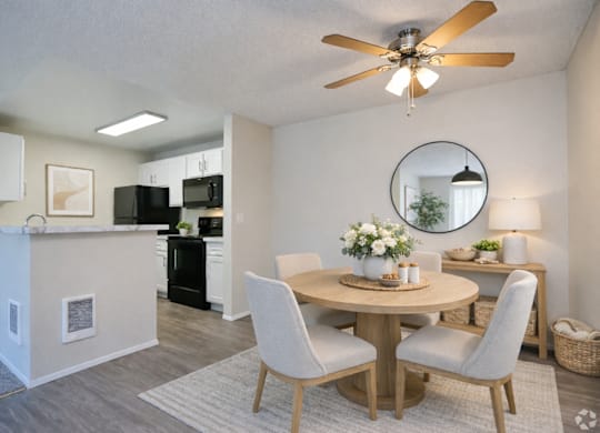 A dining room with a round table and chairs.