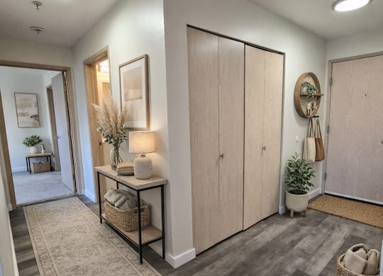 A hallway with a rug and a basket on the floor.
