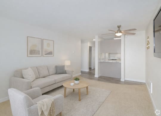 A living room with a couch, chair, and coffee table.