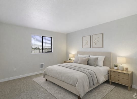 A bedroom with a bed, nightstand, and two framed pictures on the wall.