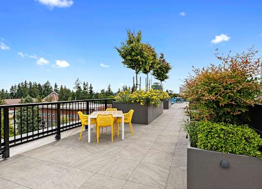 Well Landscaped terrace area with a table and chairs at Arabella Apartment Homes, Shoreline, 98155