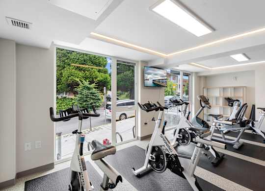 Well-Equipped Fitness Center with Exercise Equipment and Large Windows at Arabella Apartment Homes, Washington