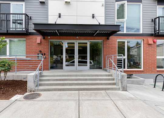View of the front of the property entrance with a ramp and stairs leading up to the door at Arabella Apartment Homes, Washington