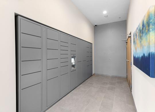a row of package lockers with a painting on the wall at Arabella Apartment Homes, Shoreline