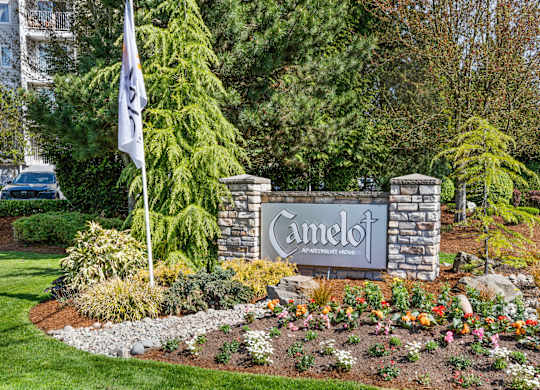 a sign in front of a building with a flag