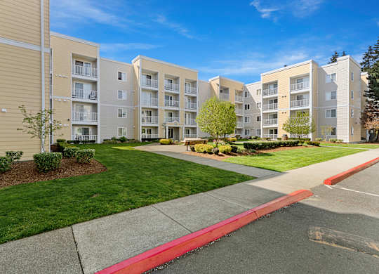 a view of the exterior of a building at the whispering winds apartments in pearland, tx  at Camelot Apartment Homes, Everett, 98204